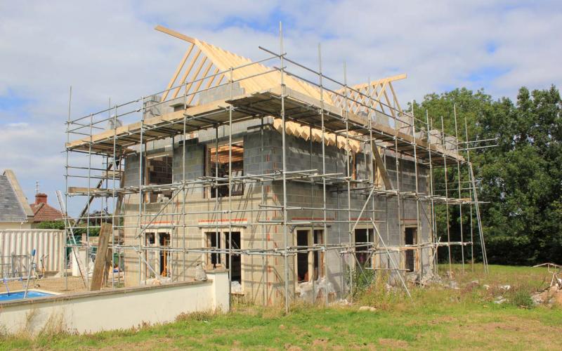 A house being built with scaffolding around it